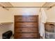 Spacious closet with a dresser and storage shelves and rods for hanging clothes at 19537 E Thornton Rd, Queen Creek, AZ 85142