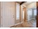 Bright entryway showcases a white front door with sidelight and tile flooring at 19537 E Thornton Rd, Queen Creek, AZ 85142