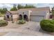 Attractive single-story home with a covered front porch, desert landscaping, and a convenient two-car garage at 19537 E Thornton Rd, Queen Creek, AZ 85142