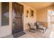 Desert-themed security door welcomes you to a sitting area on the front porch at 19537 E Thornton Rd, Queen Creek, AZ 85142