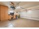 Spacious garage features epoxy flooring, storage cabinets, and an automatic door at 19537 E Thornton Rd, Queen Creek, AZ 85142