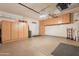 Organized garage with built-in cabinets, epoxy floors, and an exterior access door at 19537 E Thornton Rd, Queen Creek, AZ 85142