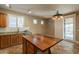 Bright kitchen featuring granite countertops, an island, stainless steel appliances, and ample cabinet space at 19537 E Thornton Rd, Queen Creek, AZ 85142