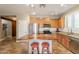 Spacious kitchen with stainless steel appliances, wood cabinets, an island, and tile floors at 19537 E Thornton Rd, Queen Creek, AZ 85142