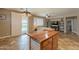 Open-concept kitchen offering access to the pool area and featuring an island with a wood countertop at 19537 E Thornton Rd, Queen Creek, AZ 85142