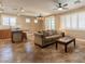 Cozy living room featuring neutral tones, tile flooring, a comfortable sofa, and bright natural light at 19537 E Thornton Rd, Queen Creek, AZ 85142
