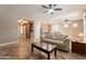 Open-concept living room with tile floors, a comfortable couch, and transitions into the kitchen area at 19537 E Thornton Rd, Queen Creek, AZ 85142