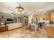 Open-concept living space includes a kitchen island, stainless appliances and a comfortable living room at 19537 E Thornton Rd, Queen Creek, AZ 85142