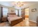 Serene main bedroom with ensuite bath, featuring tile floors, and a sliding barn door at 19537 E Thornton Rd, Queen Creek, AZ 85142