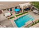 Aerial view of backyard featuring a refreshing pool, hot tub, and patio area with shade at 19537 E Thornton Rd, Queen Creek, AZ 85142