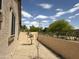 View of gravel side yard with block wall and young trees at 19537 E Thornton Rd, Queen Creek, AZ 85142