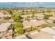 Expansive aerial view showcasing a desert community with houses, golf course, and distant mountains at 19874 N 90Th Ave, Peoria, AZ 85382