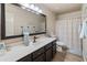 Bathroom with large mirror and updated fixtures, plus a shower/tub combo at 19874 N 90Th Ave, Peoria, AZ 85382