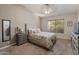 Cozy bedroom with carpet, ceiling fan, and a large window to provide plenty of natural light at 19874 N 90Th Ave, Peoria, AZ 85382