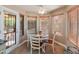 Charming breakfast nook with a round table, wood floors, and plenty of natural light from the surrounding windows at 19874 N 90Th Ave, Peoria, AZ 85382