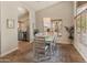 Bright dining area with wood flooring, modern light fixture, and a view of the outside garden at 19874 N 90Th Ave, Peoria, AZ 85382