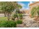 Charming home exterior with well-manicured lawn and mature trees at 19874 N 90Th Ave, Peoria, AZ 85382