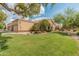 Charming single story home with a well manicured lawn, mature trees, and a two car garage at 19874 N 90Th Ave, Peoria, AZ 85382