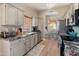 Stylish kitchen showcasing granite countertops, stainless steel appliances, gray cabinets, and adjacent dining area at 19874 N 90Th Ave, Peoria, AZ 85382