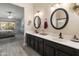 Primary bathroom features dual sinks, modern vanities, separate shower, and an adjoining bedroom at 19874 N 90Th Ave, Peoria, AZ 85382