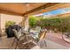 Covered patio area with outdoor dining set, ideal for entertaining guests at 19874 N 90Th Ave, Peoria, AZ 85382