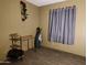 A cozy bedroom with a window, desk and golf equipment at 200 E Ivanhoe St, Chandler, AZ 85225