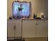 Kitchen area featuring white cabinets and a modern sink with wooden countertop at 200 E Ivanhoe St, Chandler, AZ 85225