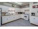 Traditional kitchen featuring white cabinetry and a neutral color scheme, offering a functional space at 200 E Ivanhoe St, Chandler, AZ 85225