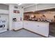 Bright kitchen with white cabinets and a serving hatch through to the dining room area at 200 E Ivanhoe St, Chandler, AZ 85225