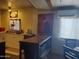 A cozy kitchen featuring white cabinets, a breakfast bar, and a large window, ready for home cooked meals at 200 E Ivanhoe St, Chandler, AZ 85225