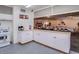Kitchen area leading to a spacious community room with tables and chairs for gatherings at 200 E Ivanhoe St, Chandler, AZ 85225