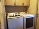 Laundry room features modern Samsung washer and dryer units with upper cabinets for storage at 200 E Ivanhoe St, Chandler, AZ 85225