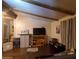 Comfortable living room featuring wooden beams, a TV, and cozy decor for relaxing and entertaining at 200 E Ivanhoe St, Chandler, AZ 85225