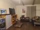Cozy living room with a comfortable couch, television, and decorative items at 200 E Ivanhoe St, Chandler, AZ 85225
