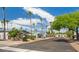 Wide street showcasing a row of manufactured homes with well-kept yards and mature palm trees at 200 E Ivanhoe St, Chandler, AZ 85225