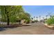 A well-maintained street lined with mature trees and manufactured homes in a quiet community at 200 E Ivanhoe St, Chandler, AZ 85225