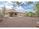 This is a shot of the backyard, which includes a covered patio, neutral rocks, and an enclosed fence at 2112 E Donald Dr, Phoenix, AZ 85024