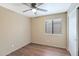 The bedroom features neutral walls and flooring with a window that allows natural light to illuminate the space at 2112 E Donald Dr, Phoenix, AZ 85024