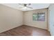 This well-lit bedroom features neutral walls and vinyl flooring with a large window and a closet at 2112 E Donald Dr, Phoenix, AZ 85024