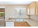 A corner of the kitchen with stainless steel appliances, cabinets, and a window at 2112 E Donald Dr, Phoenix, AZ 85024