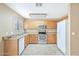 A full view of a kitchen with wooden cabinets and stainless steel appliances at 2112 E Donald Dr, Phoenix, AZ 85024