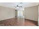 Spacious living room with dark wood floors, neutral walls, and a ceiling fan at 2112 E Donald Dr, Phoenix, AZ 85024