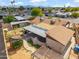 Aerial view showcasing the home's backyard with a covered patio, pergola, and lush landscaping in a quiet neighborhood at 2217 N 51St Ln, Phoenix, AZ 85035