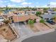 Inviting single-story home with a covered carport, desert landscaping, and mature trees located on a corner lot at 2217 N 51St Ln, Phoenix, AZ 85035