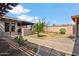 Backyard with desert landscaping, a brick pathway, and a covered patio, creating an inviting outdoor space at 2217 N 51St Ln, Phoenix, AZ 85035