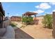 Spacious backyard with a winding walkway, mature trees, and a wooden pergola, ideal for outdoor living at 2217 N 51St Ln, Phoenix, AZ 85035