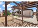 Charming backyard featuring a wooden pergola, stucco design, and covered patio providing a relaxing outdoor space at 2217 N 51St Ln, Phoenix, AZ 85035