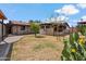 Private backyard with mature landscaping, a covered patio, and a pathway leading to a relaxing outdoor space at 2217 N 51St Ln, Phoenix, AZ 85035