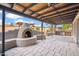 Inviting covered patio featuring an outdoor fireplace, tile floor and grill at 2217 N 51St Ln, Phoenix, AZ 85035