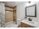 Bathroom featuring tiled shower, modern vanity with a white countertop and stylish fixtures at 2217 N 51St Ln, Phoenix, AZ 85035